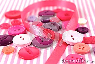 Pink and purple haberdashery buttons and craft ribbon Stock Photo