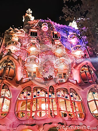 Pink and purple lighting of the walls of Casa Batllo in Barcelona at night Editorial Stock Photo