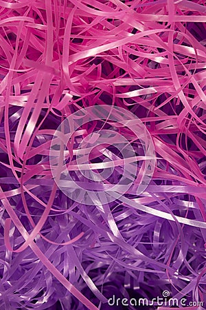 Pink and Purple shredded plastic fake Easter grass background Stock Photo