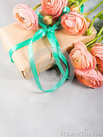 Pink ranunculus flowers and gift box Stock Photo