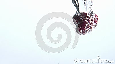 Pink raspberry fall splashed water goblet closeup. Sparkling clear aqua berries Stock Photo