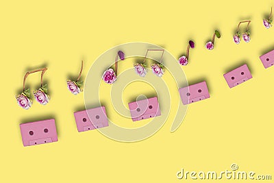 pink retro audio cassettes above them musical notes creatively combined from flowers Stock Photo