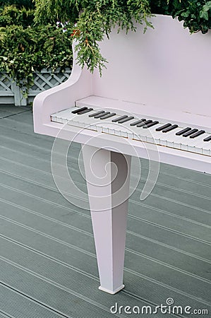 Pink retro piano decorated with flora Stock Photo