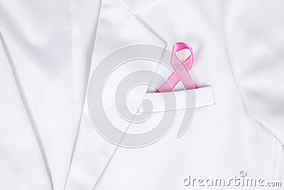 Pink ribbon inserted to the pocket of lab coat Stock Photo