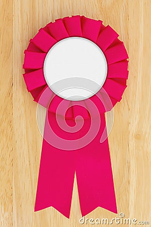 Pink ribbon on a wood desk for your award, competition, or success message Stock Photo