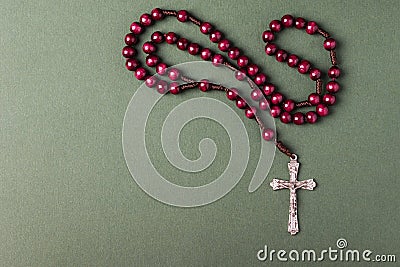 Pink Rosary on a green background. Stock Photo