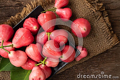 Pink rose apple on wood table Stock Photo