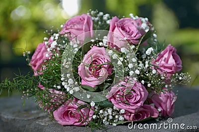 Pink rose wedding bouquet with two gold ring Stock Photo