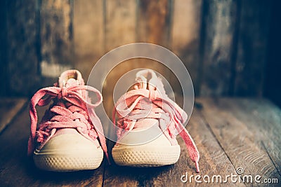 Pink shoes for children on wooden floor Stock Photo