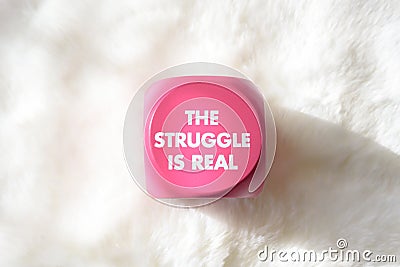 Pink sign with white lettering that says the struggle is real Stock Photo