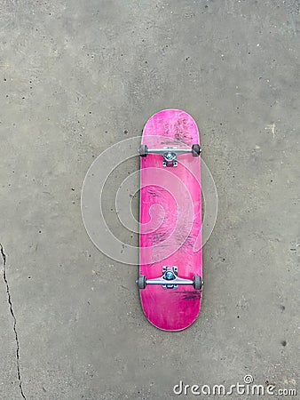 Pink Skateboard on Smooth Concrete Surface Stock Photo