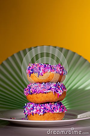 Pink sprinkle donuts in a spotlight, art nouveau style background Stock Photo