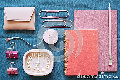 Pink stationery office supply on blue fabric desk background. flat lay, top view Stock Photo