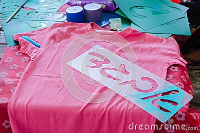 Pink T-shirt templates with letters Aleph Bet Gimel Dalet in Hebrew for drawing on a table Stock Photo