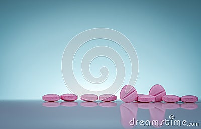 Pink tablets pills with shadow on gradient background. Pharmaceutical industry. Pharmacy products. Vitamins and supplements. Stock Photo