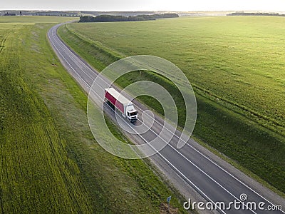 Pink Truck with Cargo Semi Trailer Moving on Road in Direction. Highway intersection junction. Aerial Top View Stock Photo