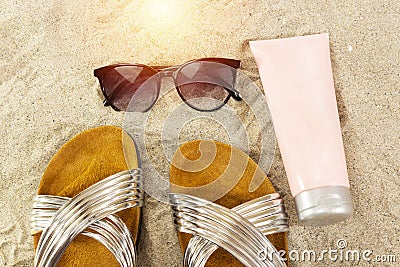 pink tube cream, and sunglasses, slippers. summer beach concept. Stock Photo