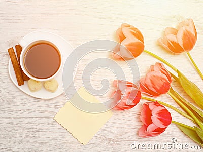 Pink tulips, blank sheet of paper, mug of coffee and cinamon, li Stock Photo