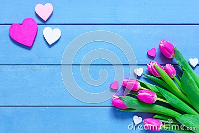 Pink Tulips Flowers and Hearts on blue wooden table for March 8, International Womens Day, Birthday , Valentines Day or Mothers da Stock Photo