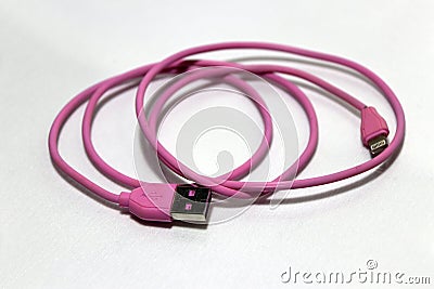 Pink used USB plug with cable on the white background. Stock Photo