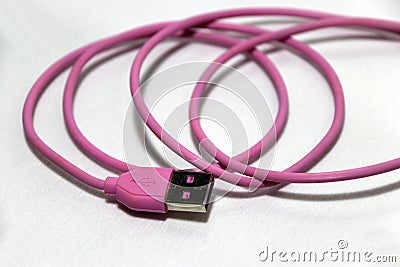 Pink used USB plug with cable on the white background. Stock Photo