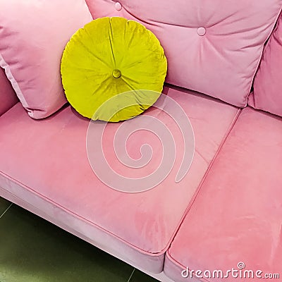 Pink velvet sofa with fancy green cushion Stock Photo