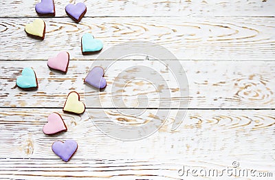 Pink, violet, yellow and green heart cookies on a white wooden b Stock Photo