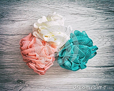 Pink, white and turquoise washcloths on the wooden background Stock Photo