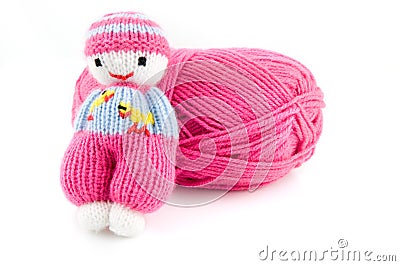 Pink wool ball with selfmade knitted doll Stock Photo