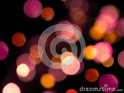 pink and yellow round soft glowing blurred lights abstract on a black background Stock Photo