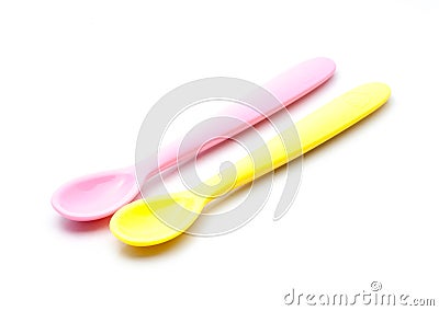 Pink and yellow silicone baby spoon Stock Photo