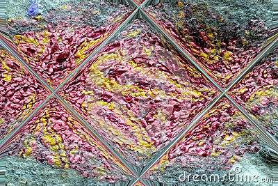 Pink and yellow wool is reflected in a glass tile Stock Photo