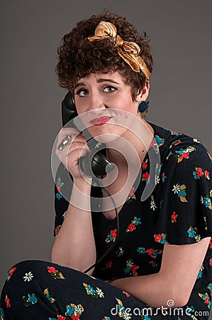 Pinup Girl Frustrated on Old Fashioned Telephone Stock Photo