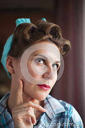 Pinup look dressed women are thinking about something that she forgot Stock Photo