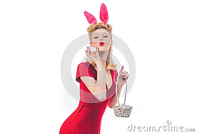 Pinup woman bunny Easter. Lovely woman in rabbit costume. Happy woman preparing for Easter with Easter egg. Stock Photo