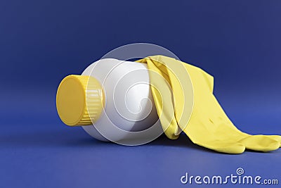 Pipe Unclogging Granules In Yellow Cap, White Plastic Bottle, Rubber Glove On Blue Purple Stock Photo
