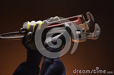 Pipe wrenches in hand of workman Stock Photo