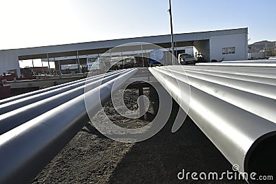Pipes for fire fighting system and extinguishing water lines in industrial building. painted steel pipes in the paintshop. Muscat Editorial Stock Photo