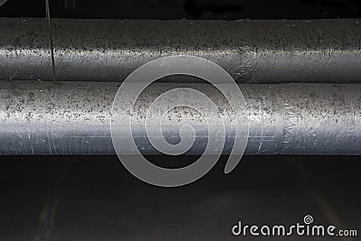 Dirty pipes suspended inside the building Stock Photo