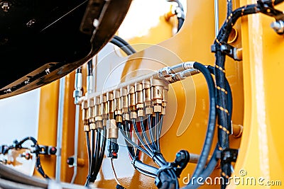 Pipes and tubes of the hydraulic system of a modern excavator tr Stock Photo