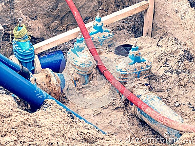 Pipes and valves underground. Repare of water supply interruption. Drink water piping Stock Photo