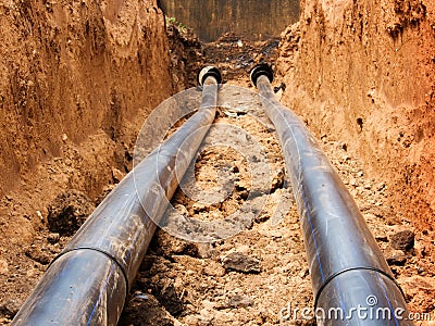 Pipes for water in a trench Stock Photo