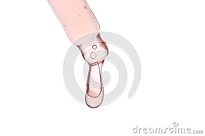 Pipette with a viscous pink cosmetic close-up. Stock Photo