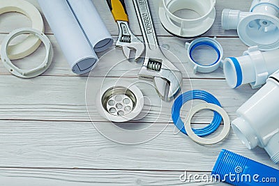 Piping accessories white sanitary plastic pipes on painted wood Stock Photo
