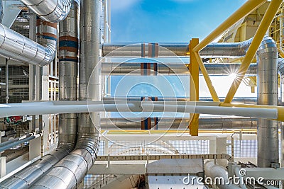 Piping with aluminum insulation of gas turbine engine to heating medium utility system of oil and gas treatment process. Stock Photo