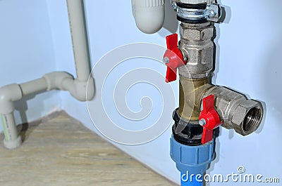Piping and plumbing fitting in the home industry of the modern era. Connecting pipe warm water floor to the manifold heating Stock Photo