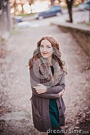 Pippin cover lady with brunette hairs deep blue eyes pout pink lips wearing cozy warm jacket sweater with fur pose sit for calenda Stock Photo