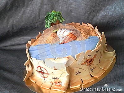 Pirate cake fondant with ship, palm, sand and map of gold riches Stock Photo