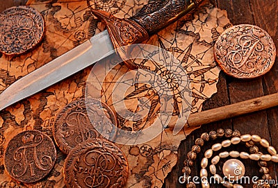 Pirate still life with dagger and map Stock Photo