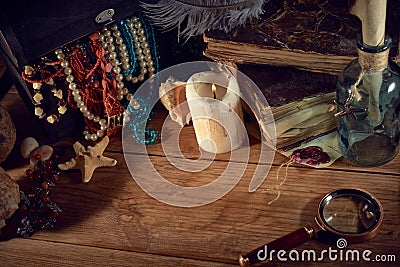 Pirate still life with a treasure chest on wooden table Stock Photo